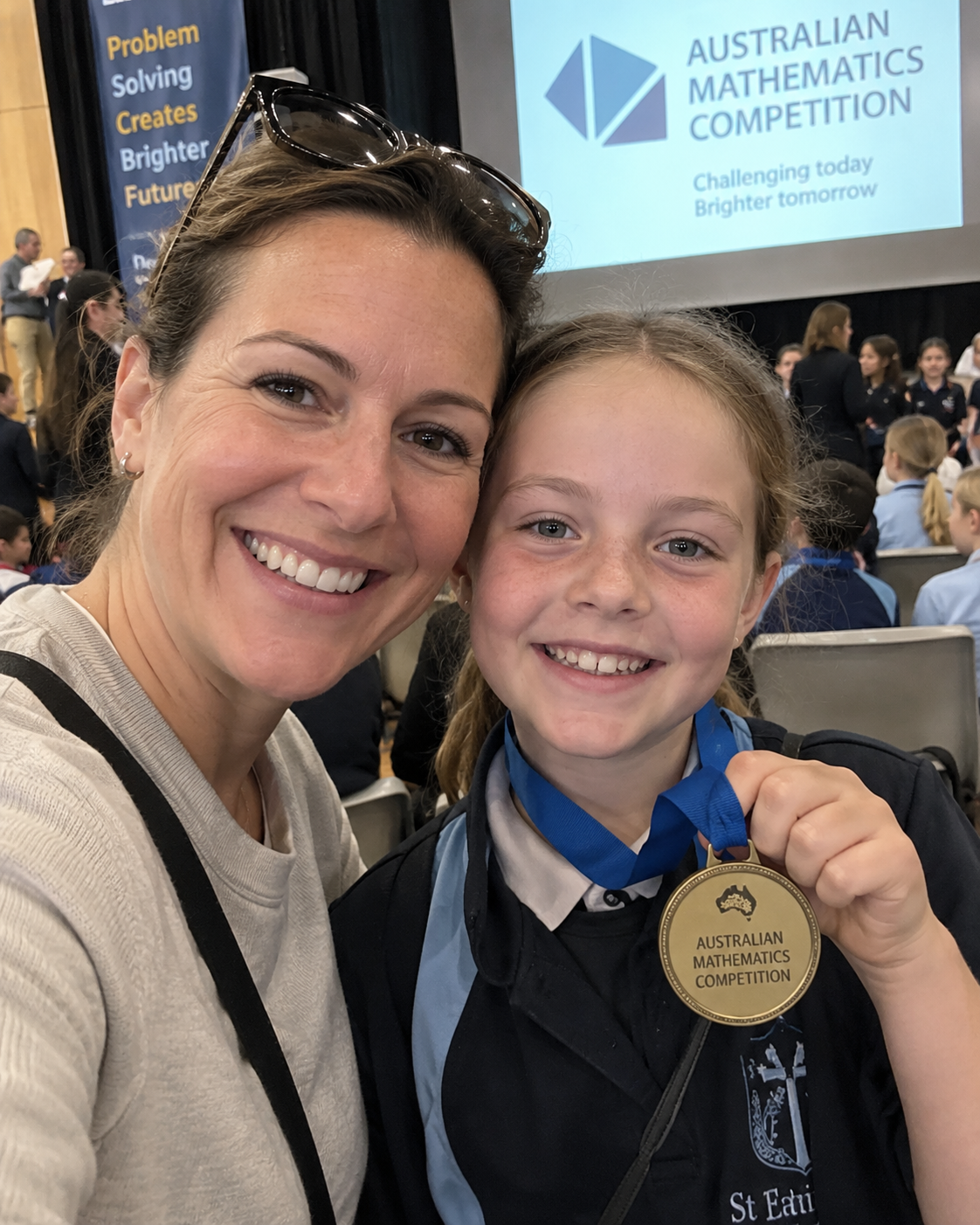 Mother and daughter with her maths competition medal
